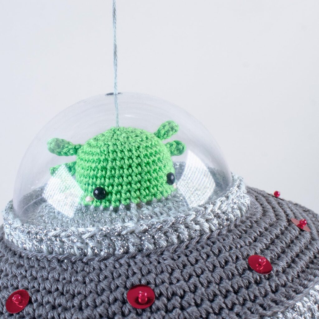This Crochet Kit Flying Saucer Kit Features an Alien and a Cow and It's a Wind-Up Music Box!